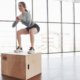 On the edge of the box. Sportive young woman have fitness day in the gym at morning time.