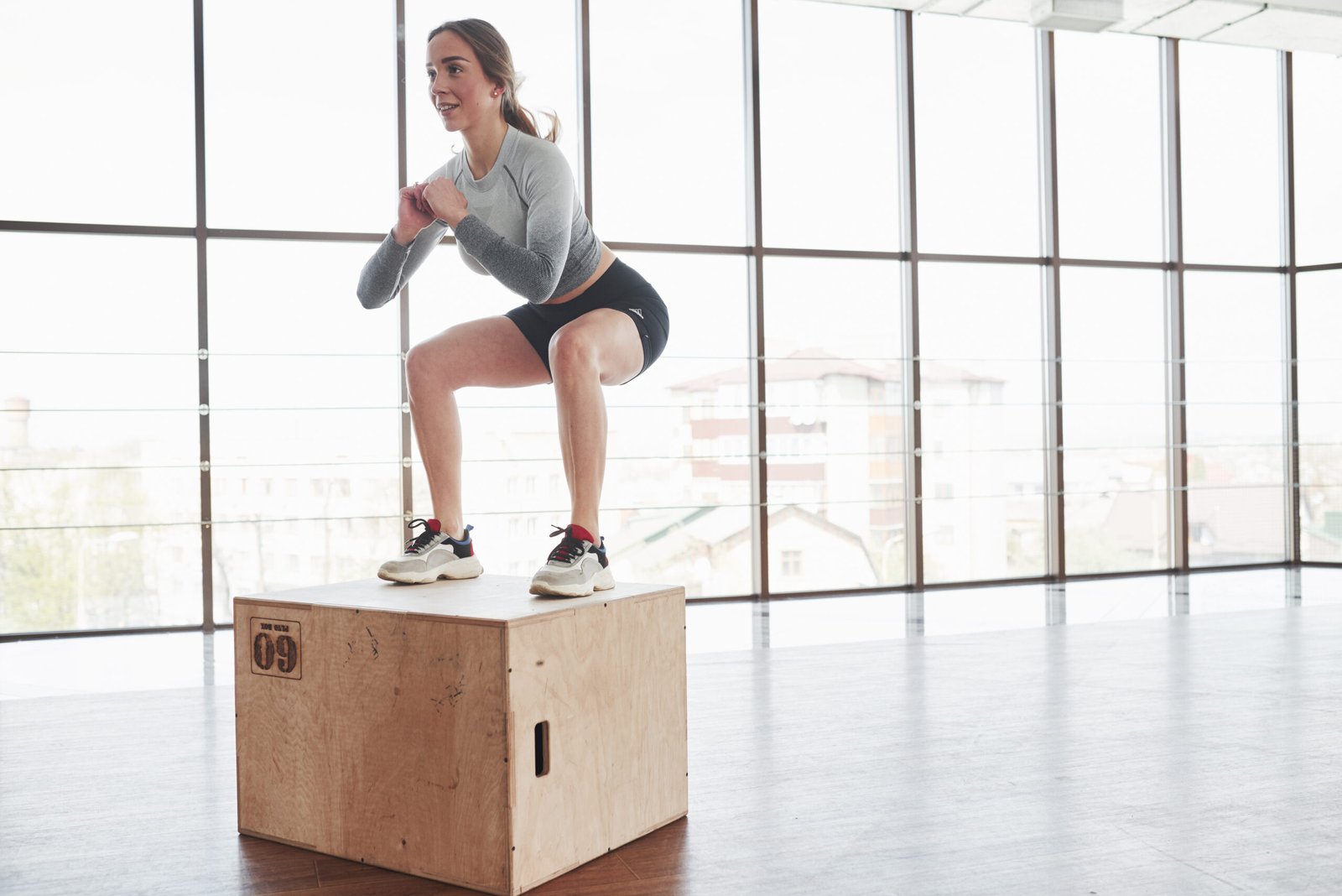 On the edge of the box. Sportive young woman have fitness day in the gym at morning time.